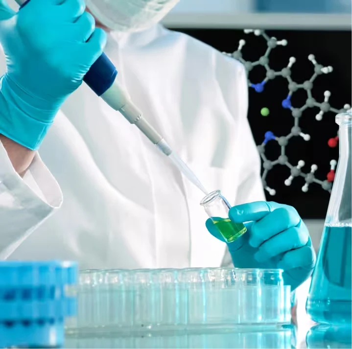 Laboratory technician pipetting a sample during quality testing